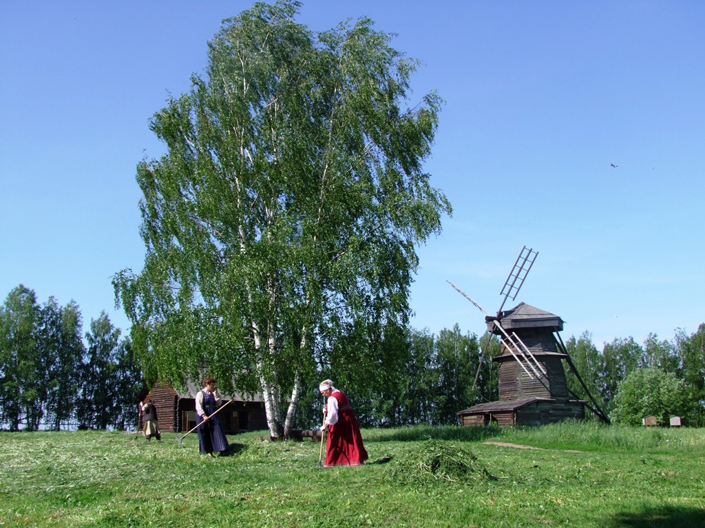 La vie paysanne, au fond deux immenses moulins à vent.